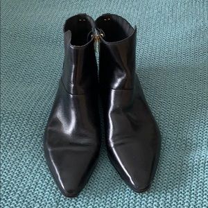 Black leather flat ankle booties.
